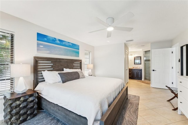 bedroom with connected bathroom, visible vents, multiple windows, and light tile patterned flooring