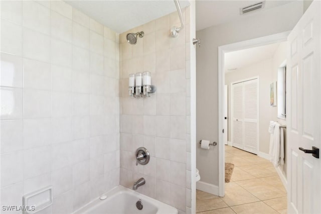 bathroom featuring visible vents, toilet, tile patterned flooring, tub / shower combination, and baseboards