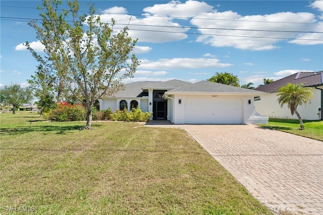 ranch-style home with decorative driveway, a garage, a front yard, and stucco siding