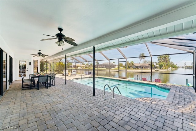 outdoor pool with a water view, a patio, a lanai, and a ceiling fan