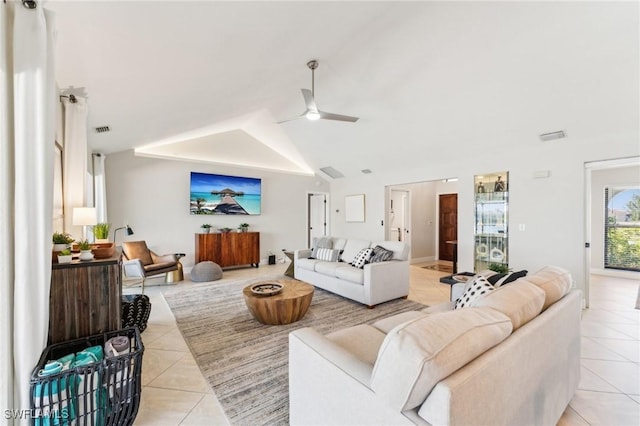 living area featuring light tile patterned flooring, visible vents, a ceiling fan, and vaulted ceiling