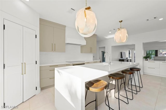 kitchen with light countertops, visible vents, and a sink