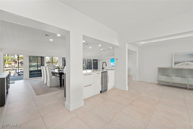 kitchen with light countertops, modern cabinets, visible vents, and white cabinets