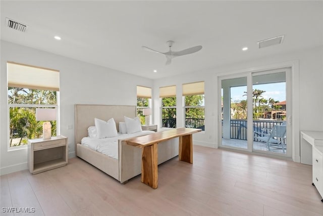 bedroom with visible vents, multiple windows, light wood-style floors, and access to exterior