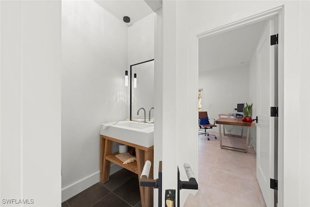 bathroom featuring tile patterned flooring and baseboards