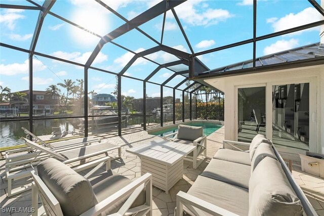 view of patio featuring a lanai, a water view, an outdoor pool, and an outdoor hangout area