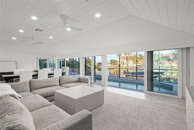 living room with tile patterned flooring, visible vents, lofted ceiling, and recessed lighting