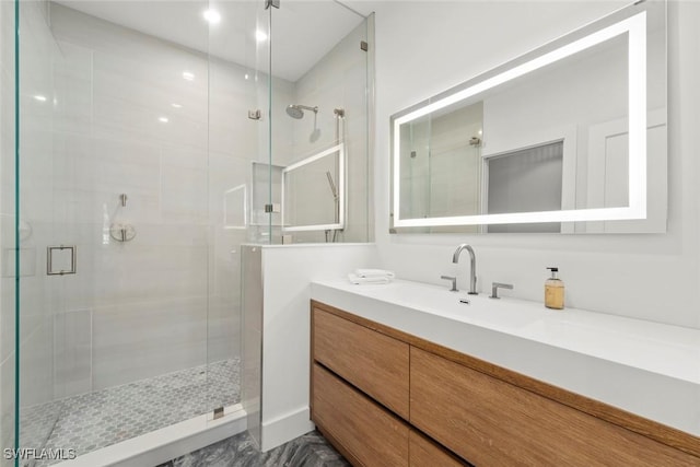 full bath with a shower stall and vanity