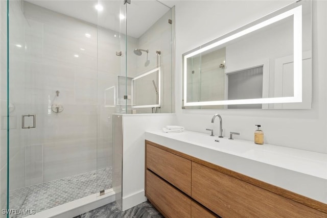 bathroom with a stall shower and vanity