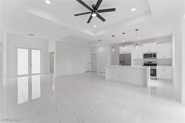 unfurnished living room featuring ceiling fan, recessed lighting, visible vents, french doors, and a raised ceiling