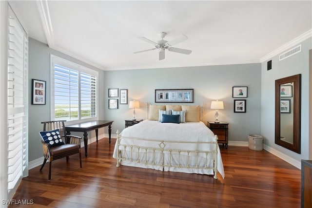 bedroom featuring wood finished floors, visible vents, and ornamental molding