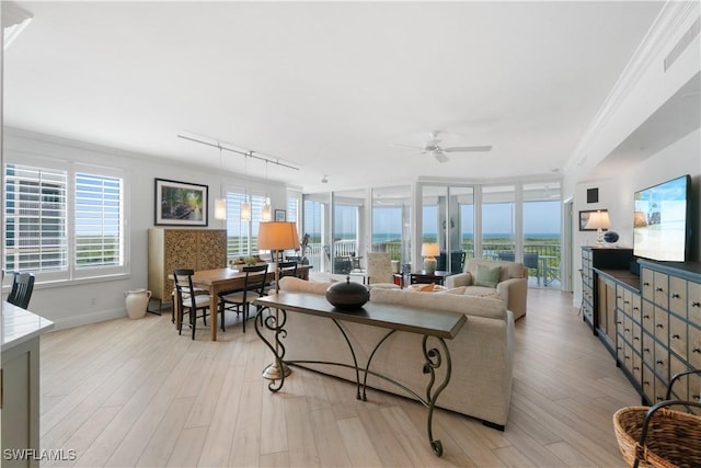 living room featuring track lighting, visible vents, light wood-type flooring, and ceiling fan