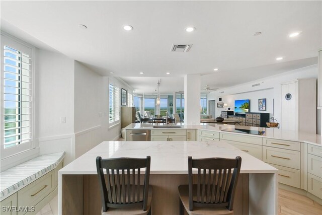 kitchen with visible vents, black electric stovetop, open floor plan, a large island, and stainless steel dishwasher