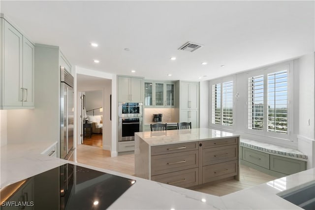 kitchen featuring visible vents, recessed lighting, appliances with stainless steel finishes, and light stone countertops