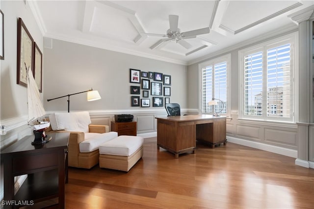 home office featuring crown molding, ceiling fan, wainscoting, wood finished floors, and coffered ceiling