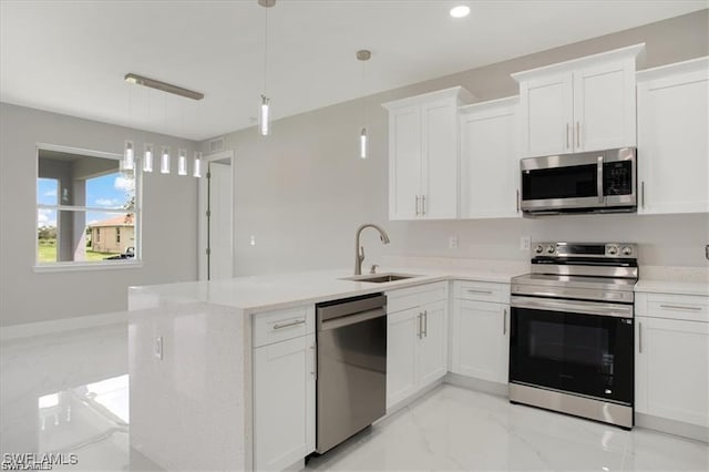 kitchen with marble finish floor, appliances with stainless steel finishes, a sink, and white cabinets