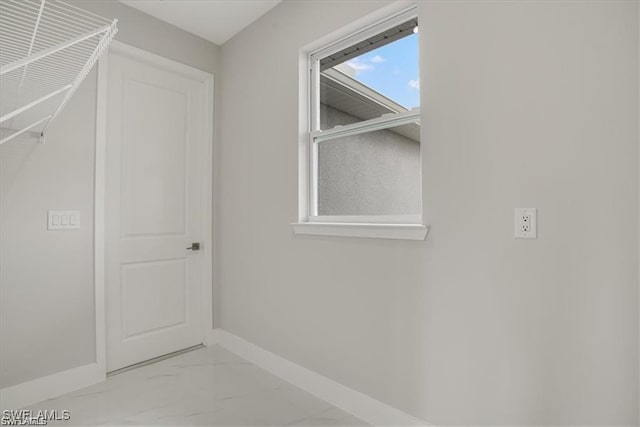 spacious closet with marble finish floor