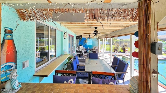 sunroom with a ceiling fan