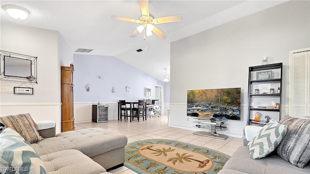 living area featuring light tile patterned floors, visible vents, lofted ceiling, and a ceiling fan