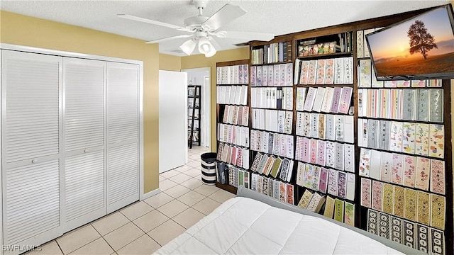 tiled bedroom featuring a ceiling fan, visible vents, a closet, and a textured ceiling