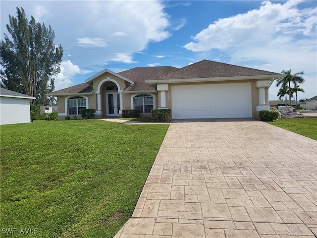 view of front of home featuring a garage, french doors, decorative driveway, stucco siding, and a front yard