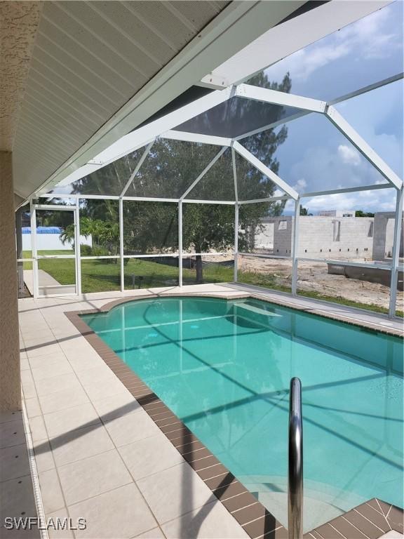 outdoor pool with a lanai and a patio