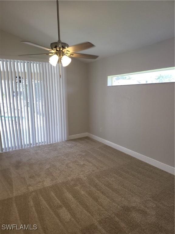 unfurnished room with carpet floors and baseboards