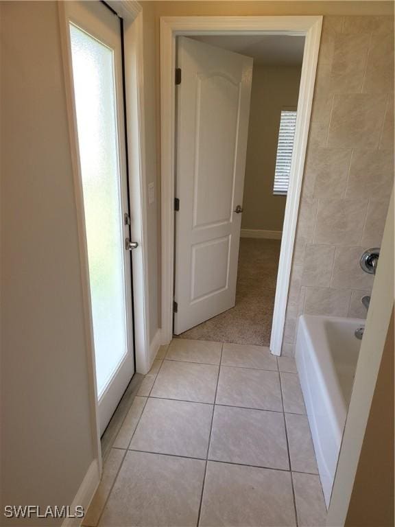 bathroom with baseboards and tile patterned floors