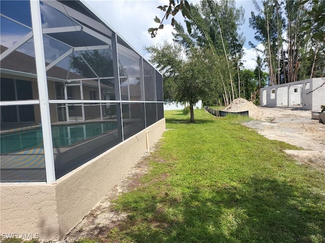 view of yard featuring glass enclosure and an outdoor pool