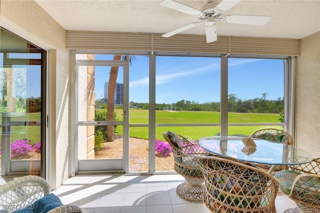 sunroom / solarium featuring ceiling fan