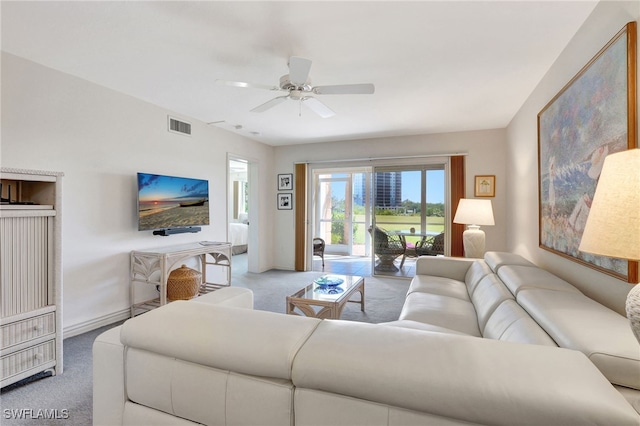 carpeted living room with visible vents, ceiling fan, and baseboards