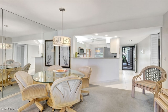 dining room with light carpet, light tile patterned floors, and recessed lighting