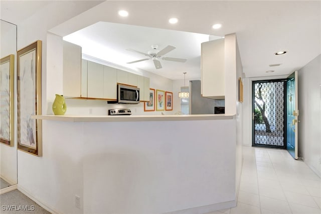 kitchen featuring electric stove, recessed lighting, light countertops, stainless steel microwave, and ceiling fan