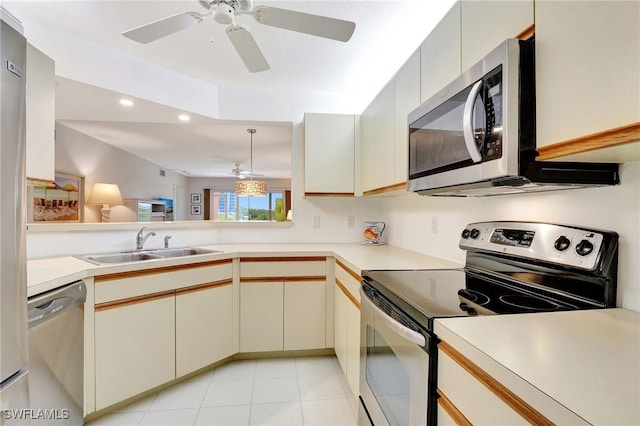 kitchen with stainless steel appliances, recessed lighting, light countertops, and a sink