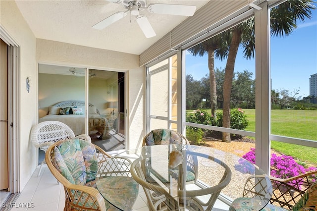 sunroom featuring ceiling fan