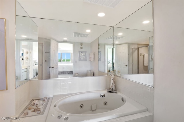 ensuite bathroom with visible vents, a whirlpool tub, and ensuite bathroom