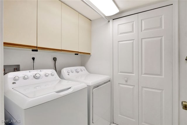 laundry room with washer and dryer and cabinet space