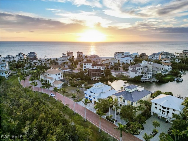 drone / aerial view featuring a residential view and a water view