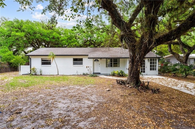 ranch-style home with brick siding and fence