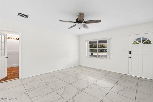 unfurnished room with visible vents, baseboards, marble finish floor, and ceiling fan