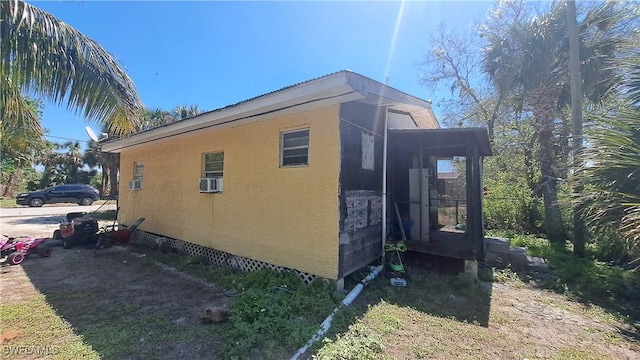 view of side of home with stucco siding