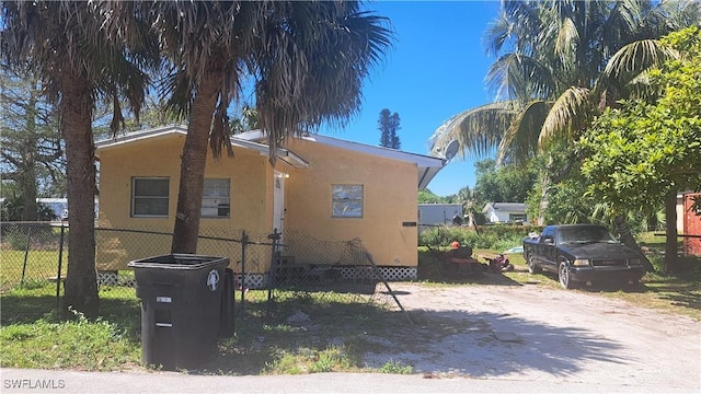 view of property exterior featuring fence and stucco siding