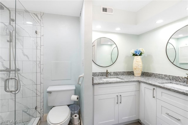 full bath with a stall shower, visible vents, a sink, and double vanity