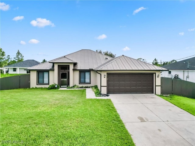 view of front of house featuring concrete driveway, an attached garage, a standing seam roof, fence, and a front yard