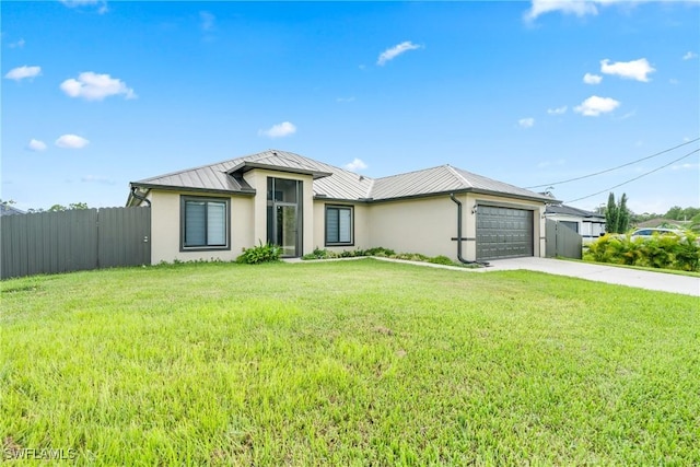 view of front of house with driveway, stucco siding, a standing seam roof, fence, and a front yard