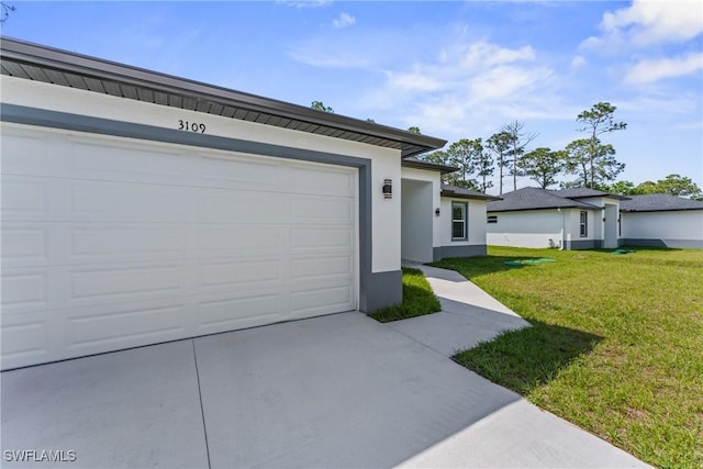 garage featuring concrete driveway