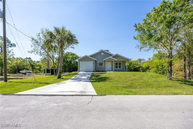 view of front of home with a garage, driveway, and a front lawn