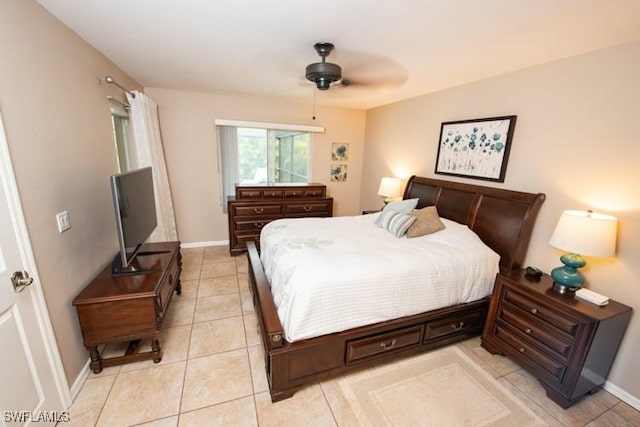 bedroom featuring light tile patterned flooring, ceiling fan, and baseboards