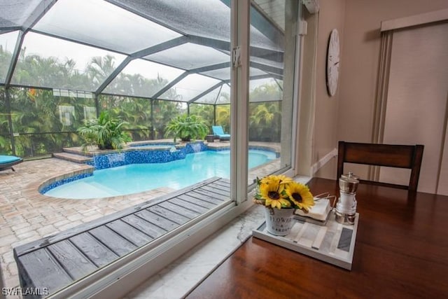 pool with a patio and an in ground hot tub