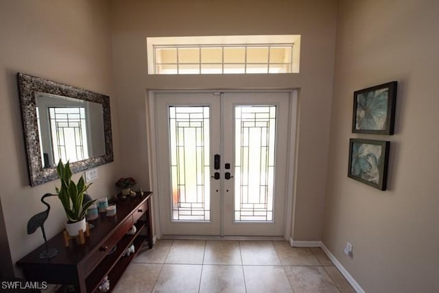 entrance foyer with french doors, baseboards, and light tile patterned floors